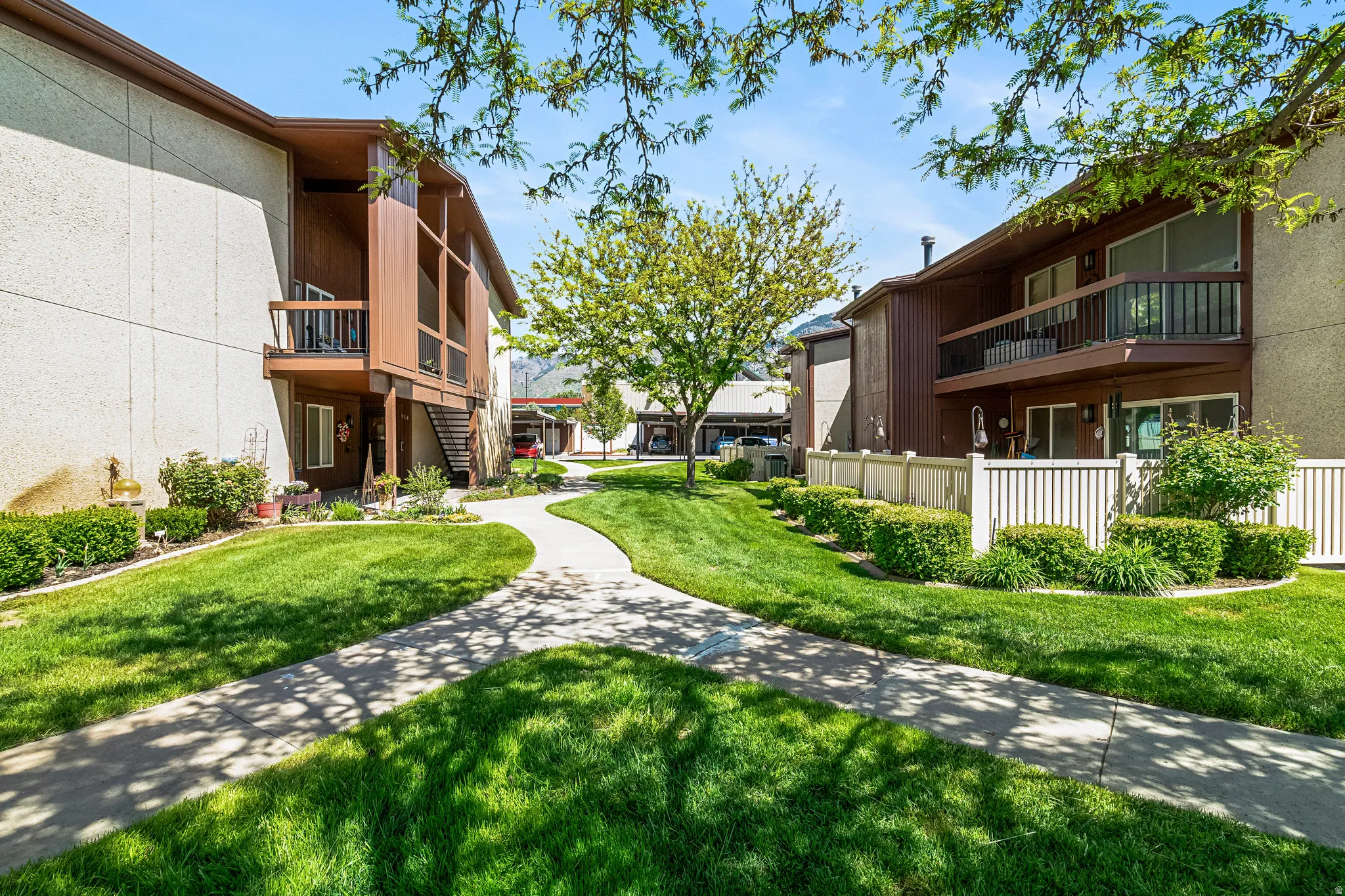 Lush green spaces featuring manicured lawns and mature trees