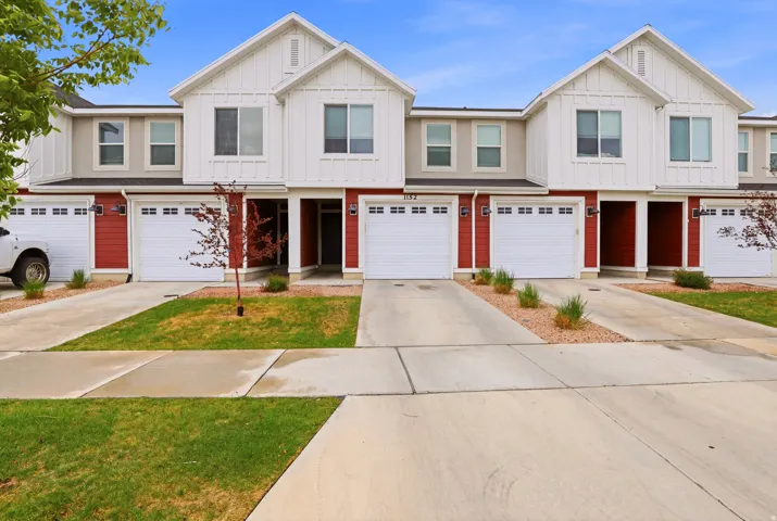 Contemporary townhome exterior with red siding and white trim