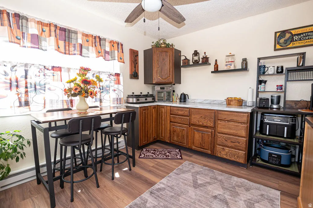 Well-appointed kitchen featuring wood-finish flooring, white countertops, and wood cabinetry
