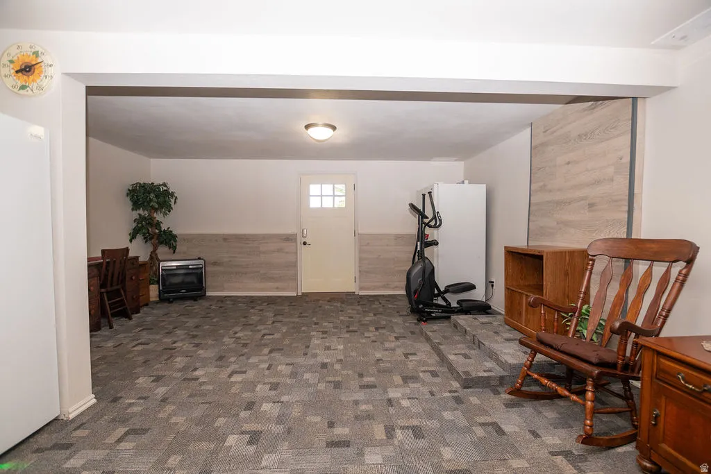 Spacious finished area featuring patterned carpet flooring and a neutral color palette
