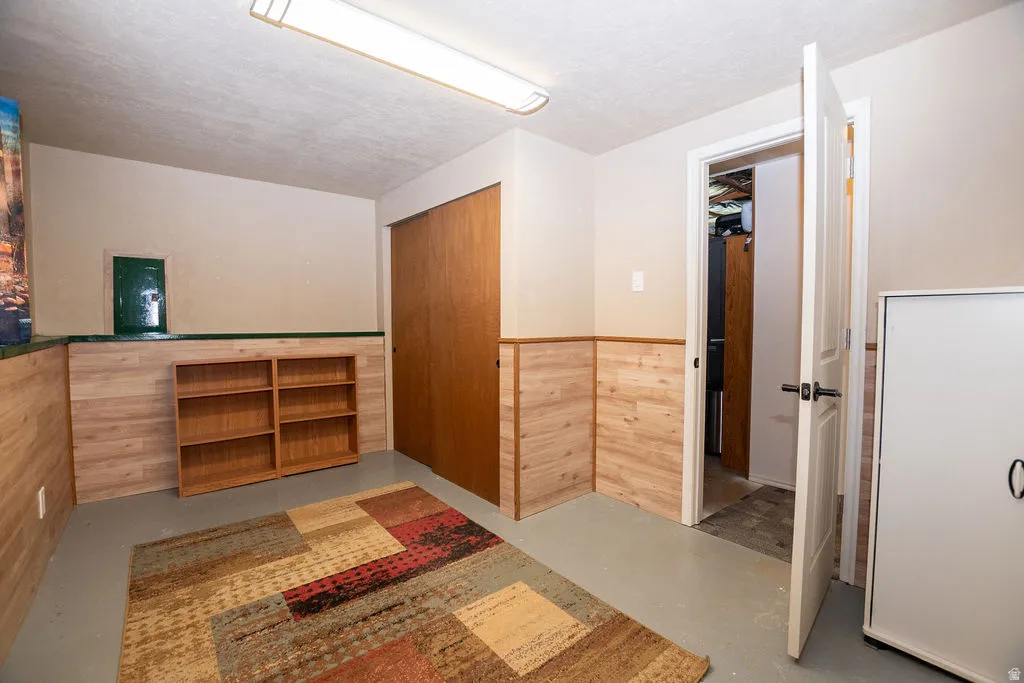 Room featuring light-colored walls and wood-finish wainscoting