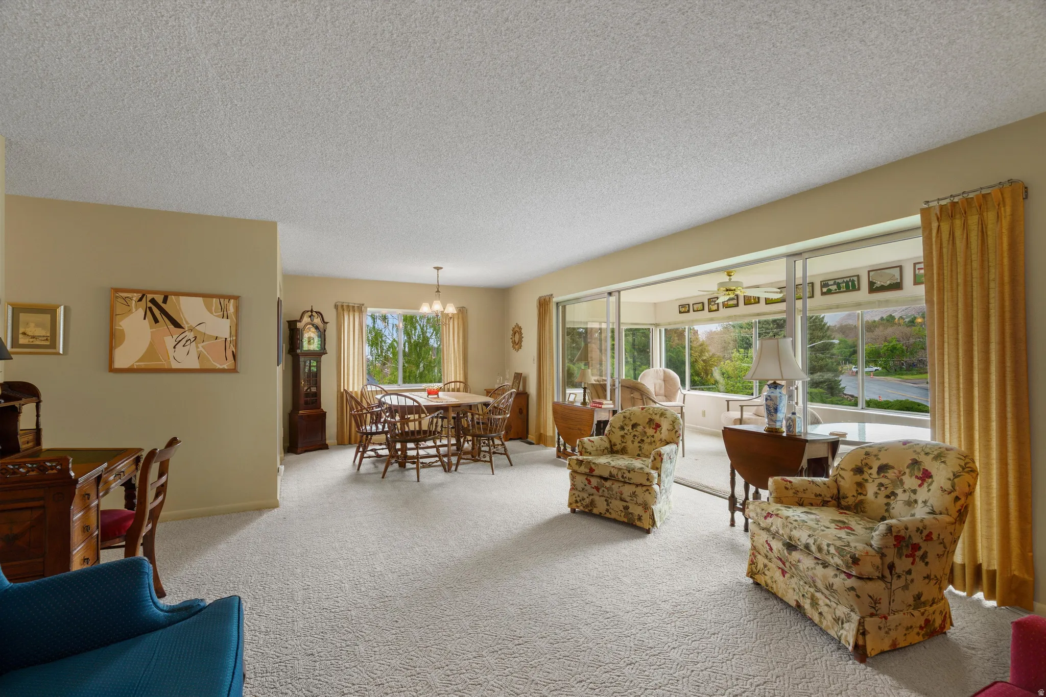 Spacious living area with light-colored carpeting and neutral wall tones