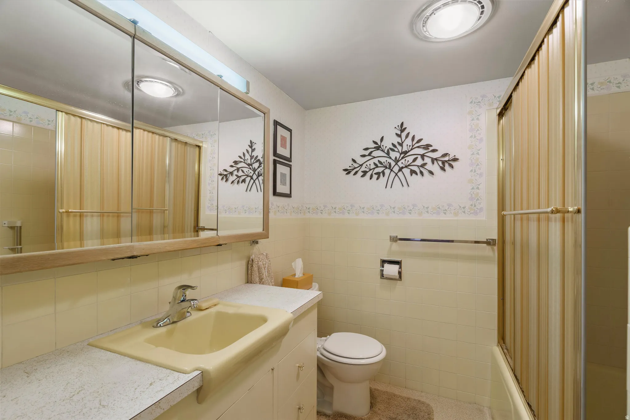 Bathroom featuring a built-in vanity with a yellow basin, white laminate countertop, and chrome faucet