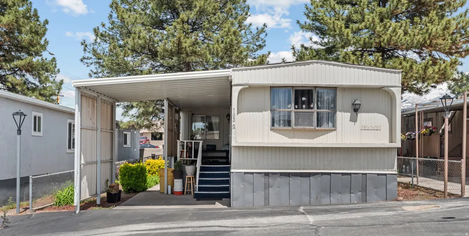 Manufactured residence featuring horizontal siding and a covered carport