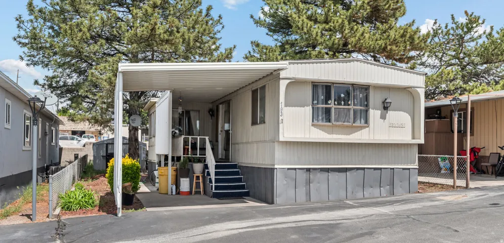 Light-colored siding exterior with a covered carport