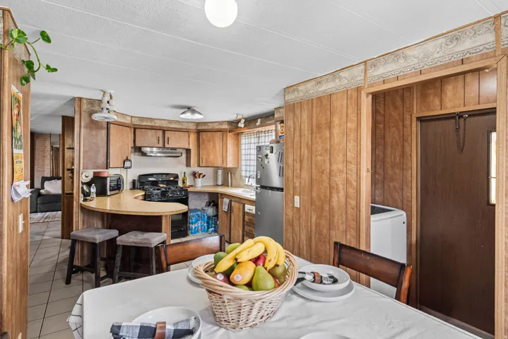 Kitchen featuring wood-finish cabinetry and paneling