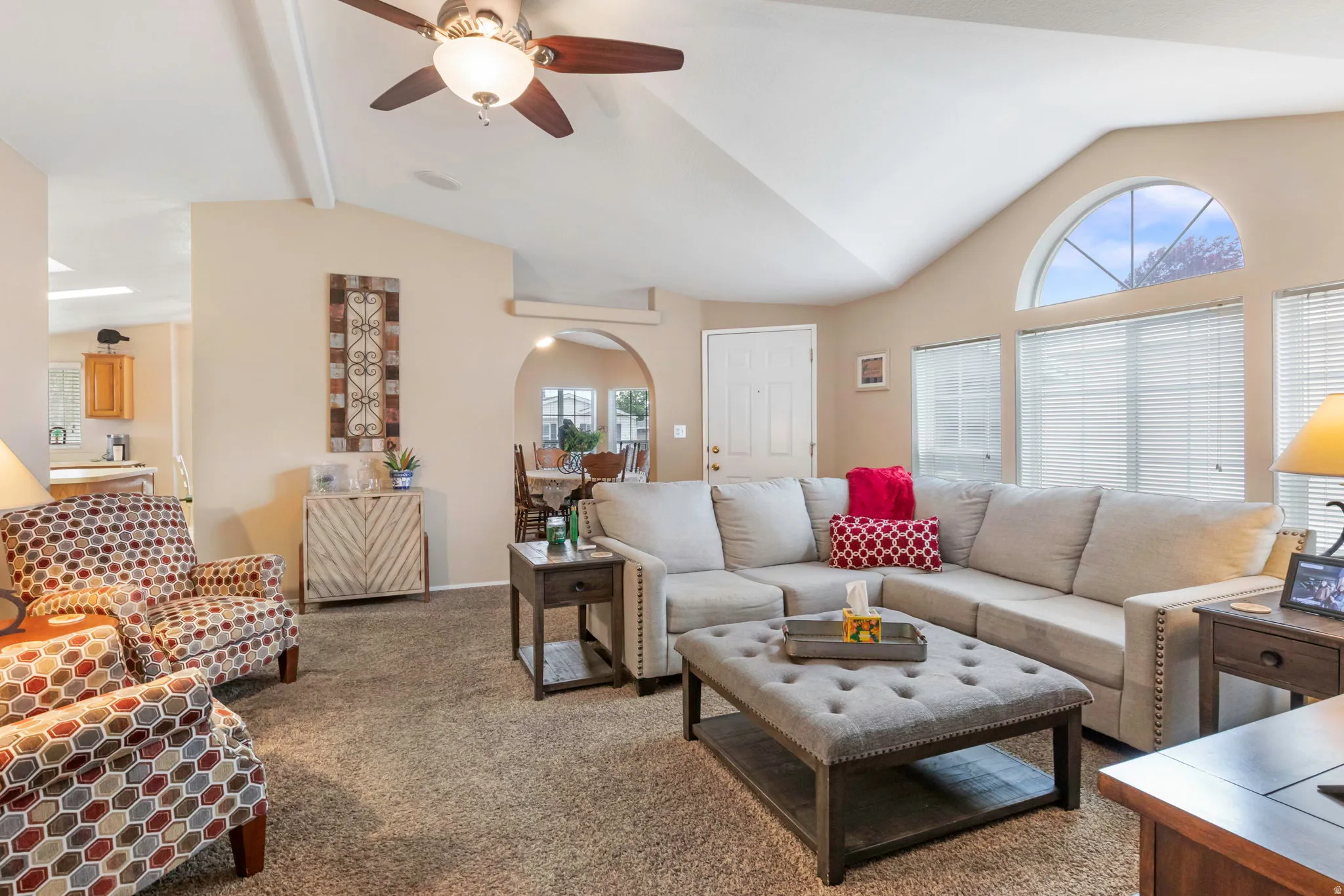 Living area featuring vaulted ceilings with exposed beams