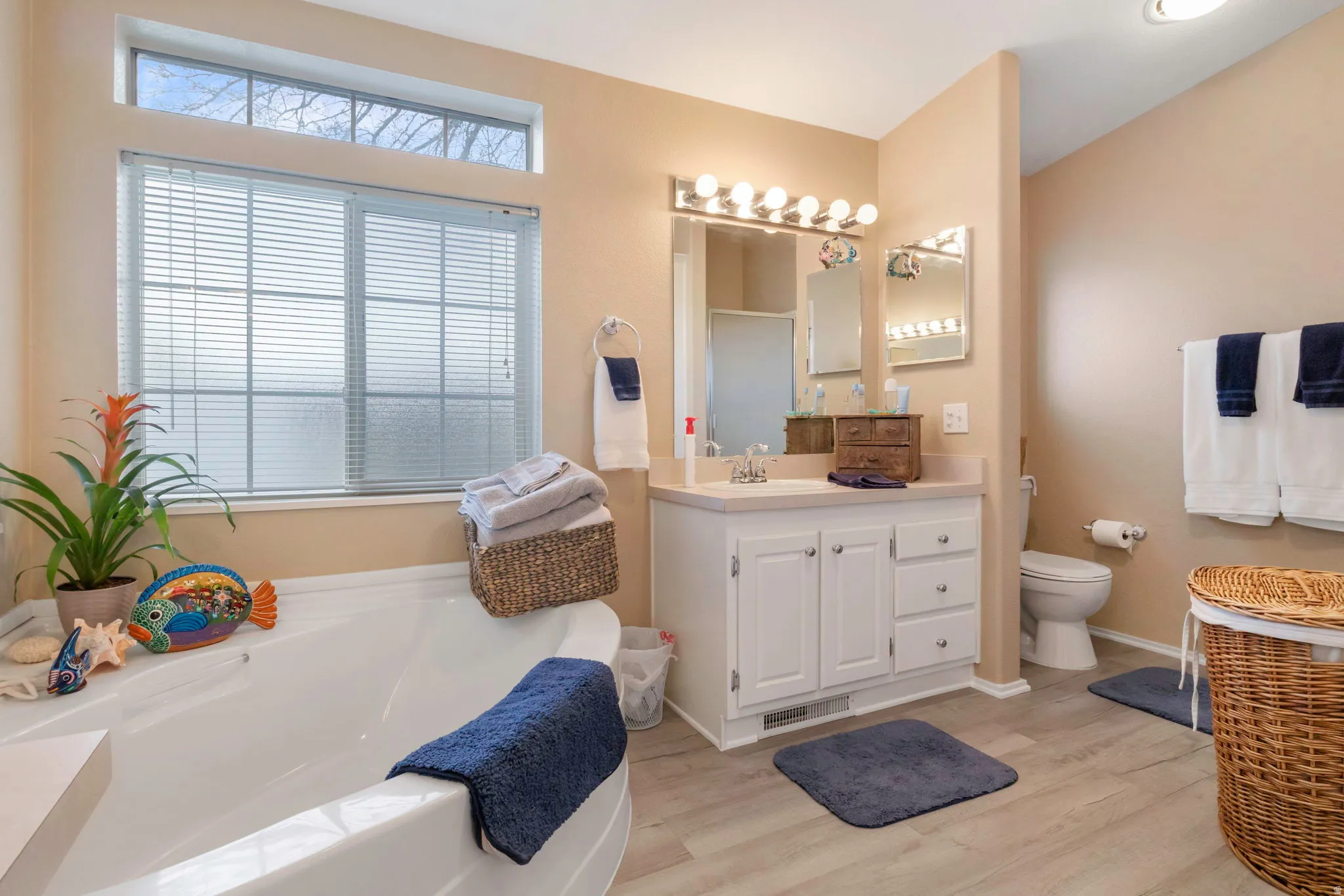 Soaking tub with a large window and upper transom window