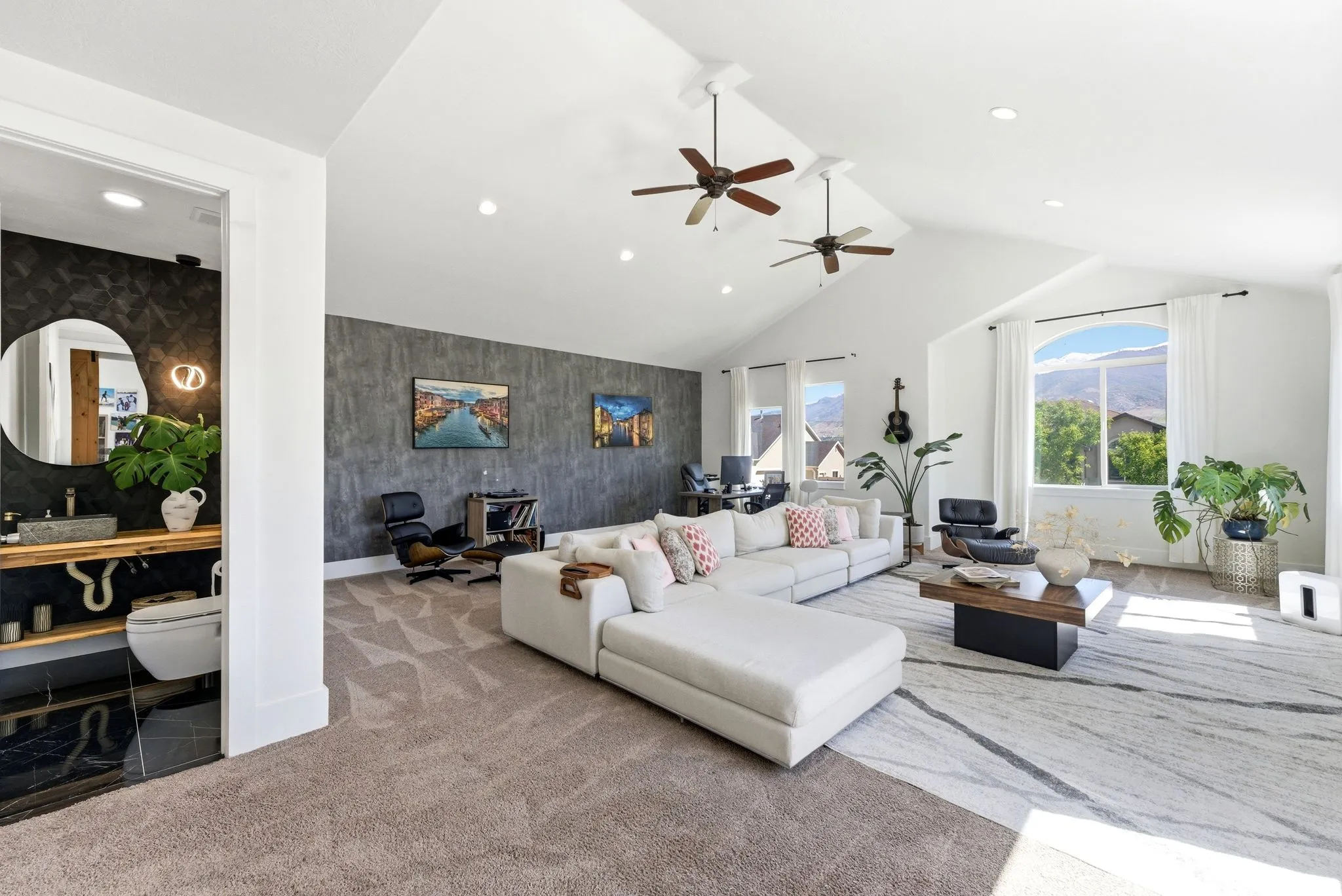 Carpeted living room featuring an accent wall, a high ceiling, recessed lighting, wallpapered walls, and ceiling fan