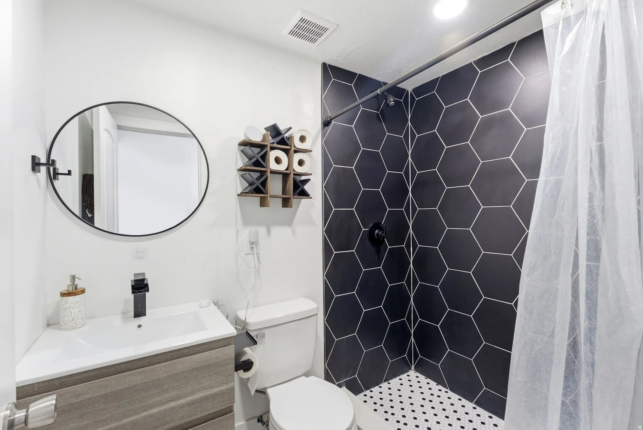 Bathroom featuring a stall shower and vanity