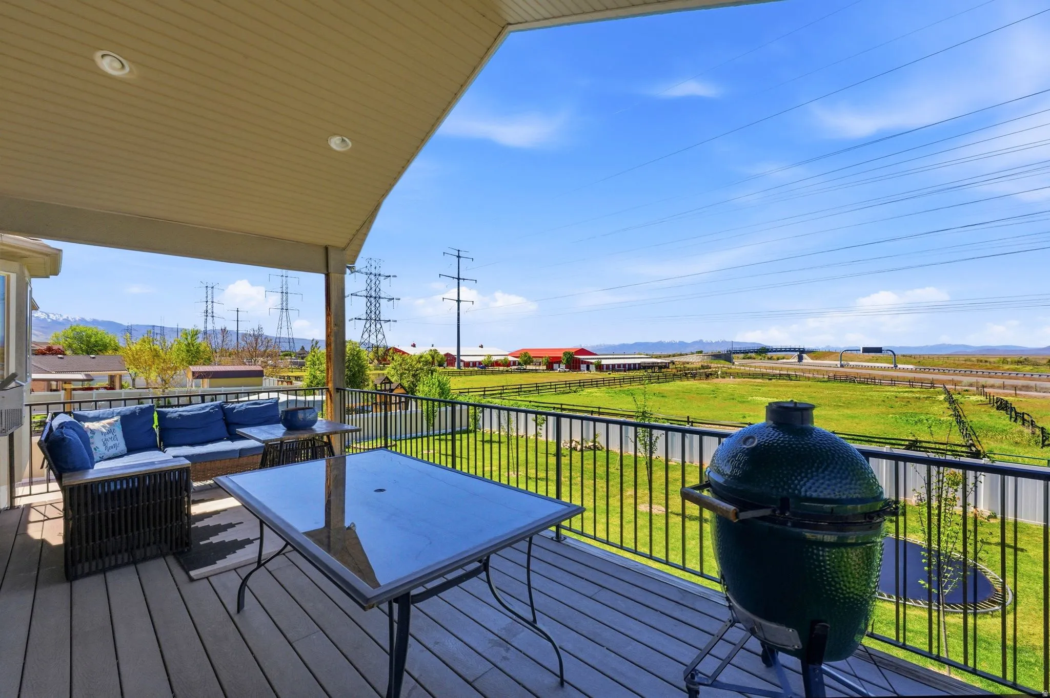 Wooden deck featuring a lawn, area for grilling, outdoor seating, and a mountain view