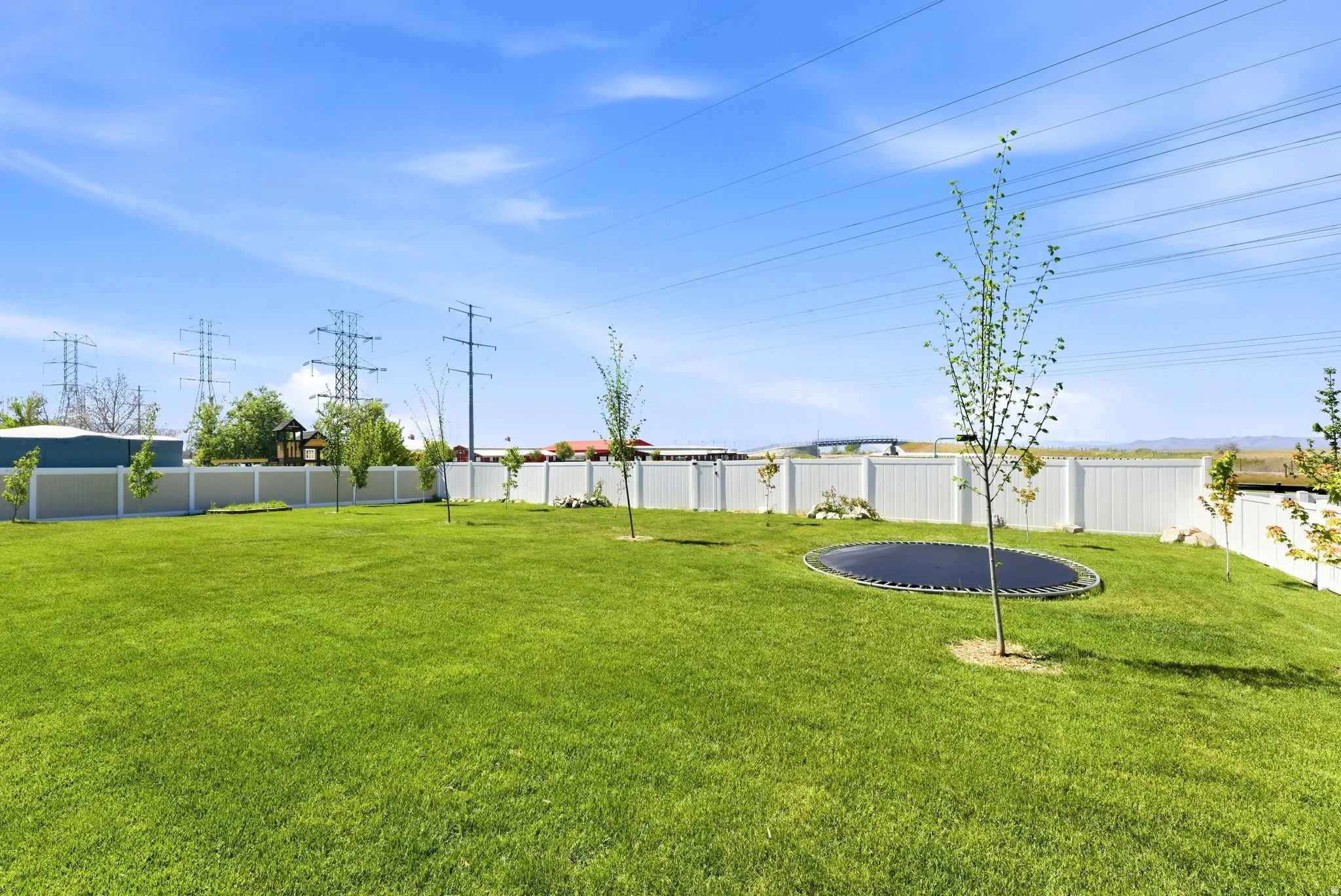 Fenced backyard with a trampoline