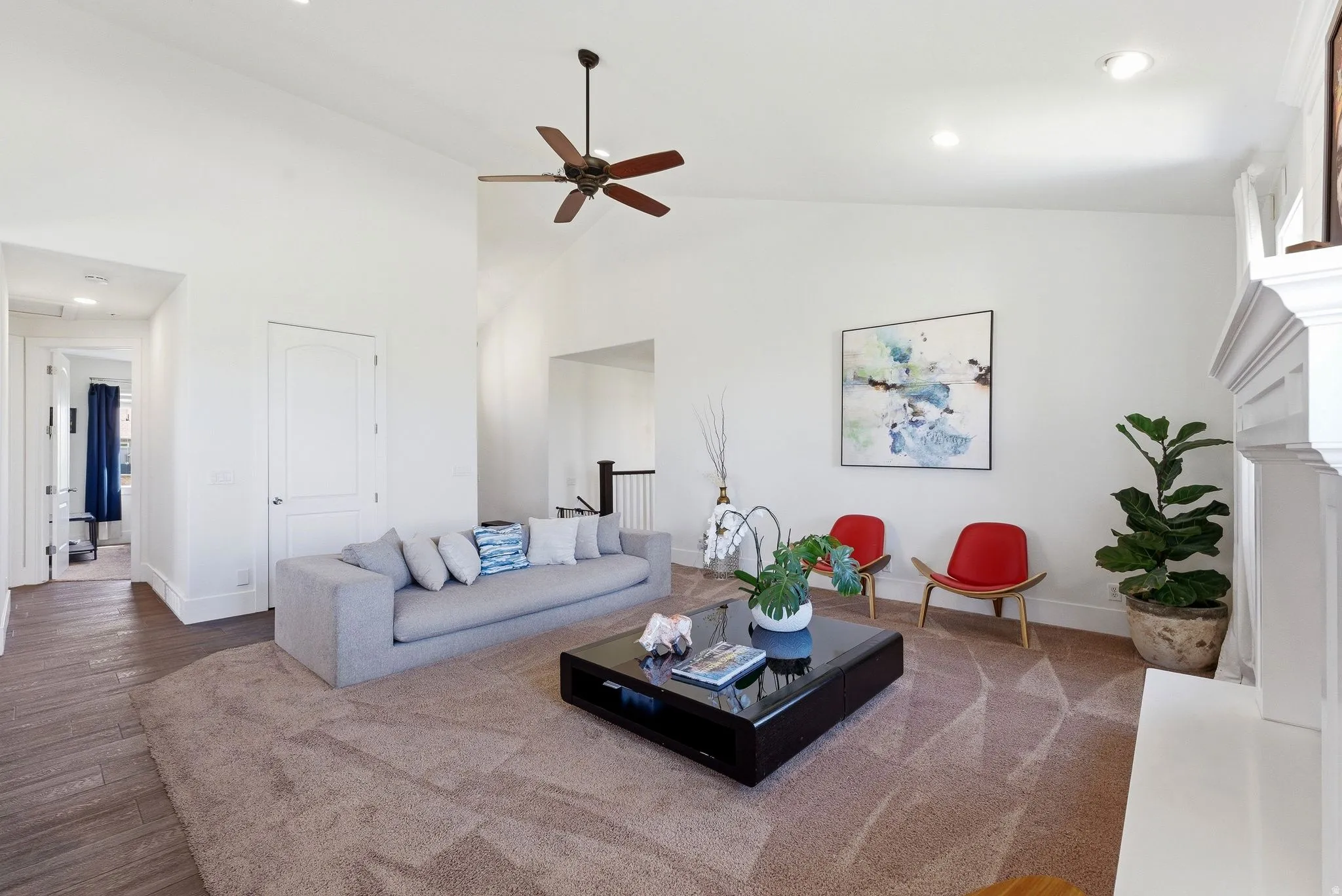 Living area featuring recessed lighting, a ceiling fan, wood-type flooring, lofted ceiling, and a fireplace