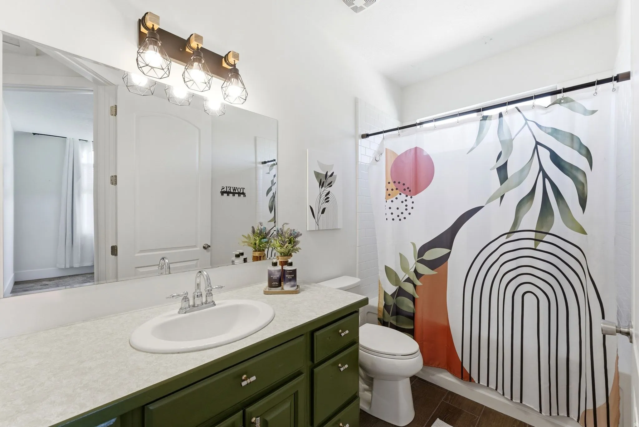 Bathroom featuring vanity and shower / tub combo with curtain