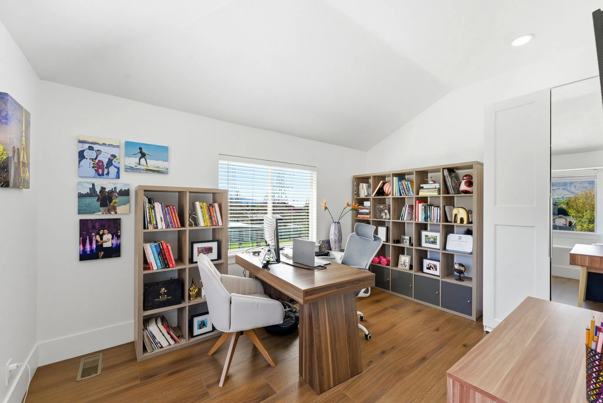 Office area featuring vaulted ceiling and wood finished floors