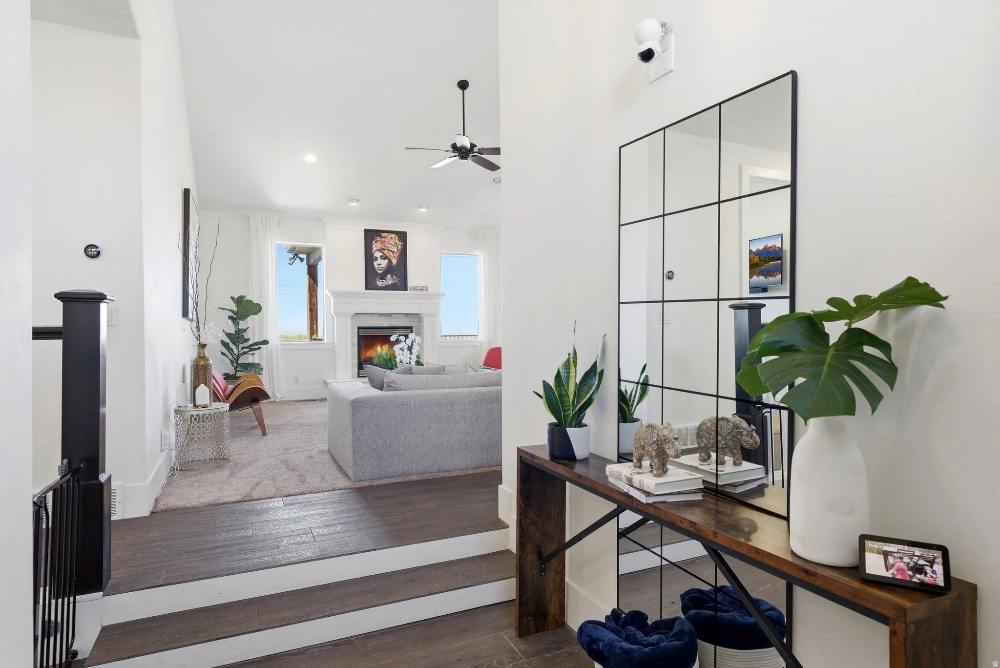 Office space with hardwood / wood-style floors, ceiling fan, and a premium fireplace