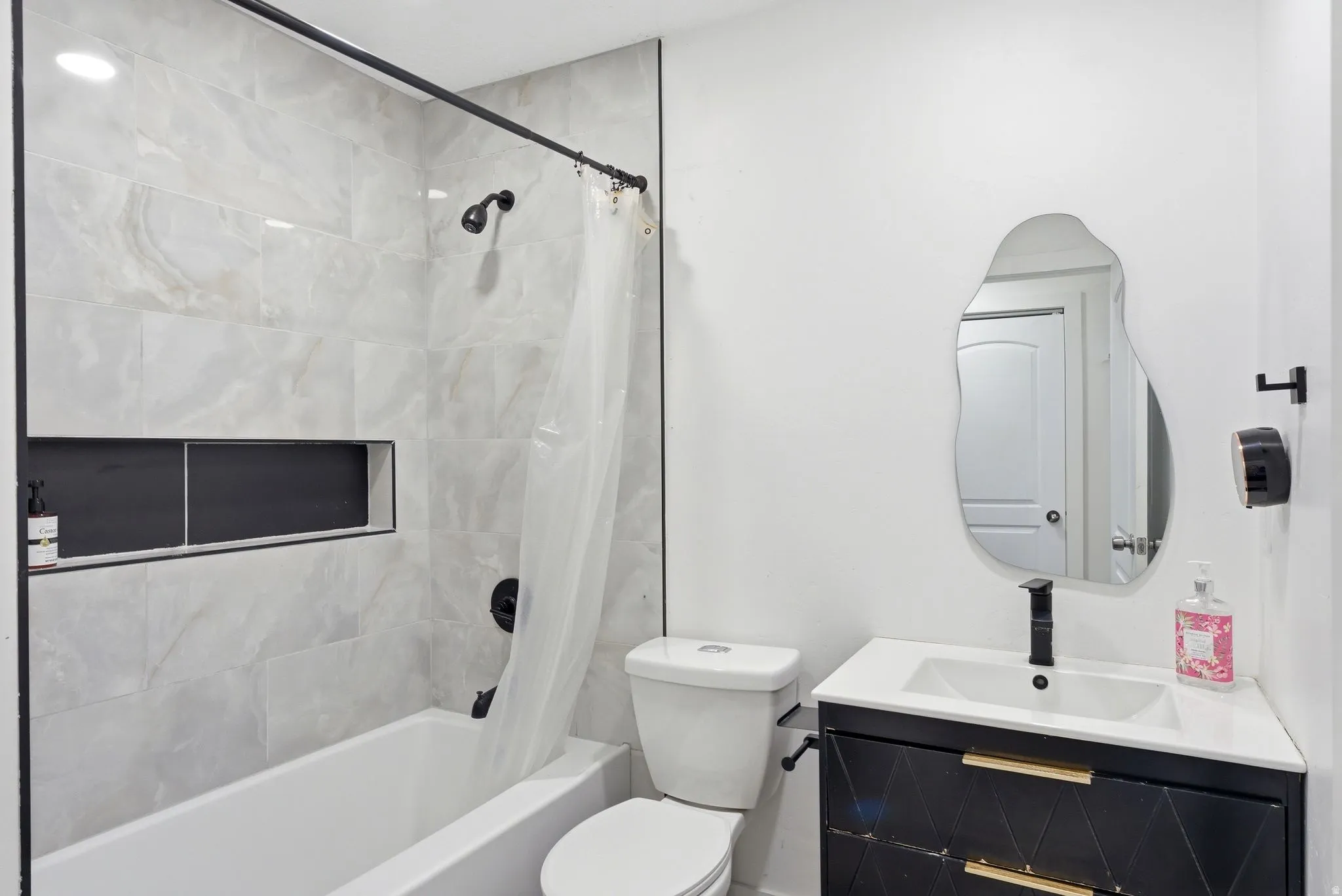 Bathroom with vanity and shower / tub combo with curtain