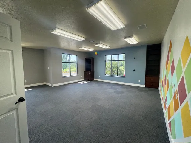 Spacious room with gray modular carpet flooring