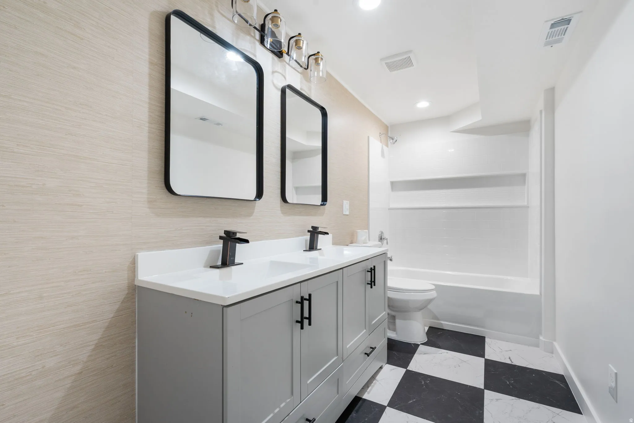 Dual vanity with matte black faucets, quartz countertops, and integrated sinks