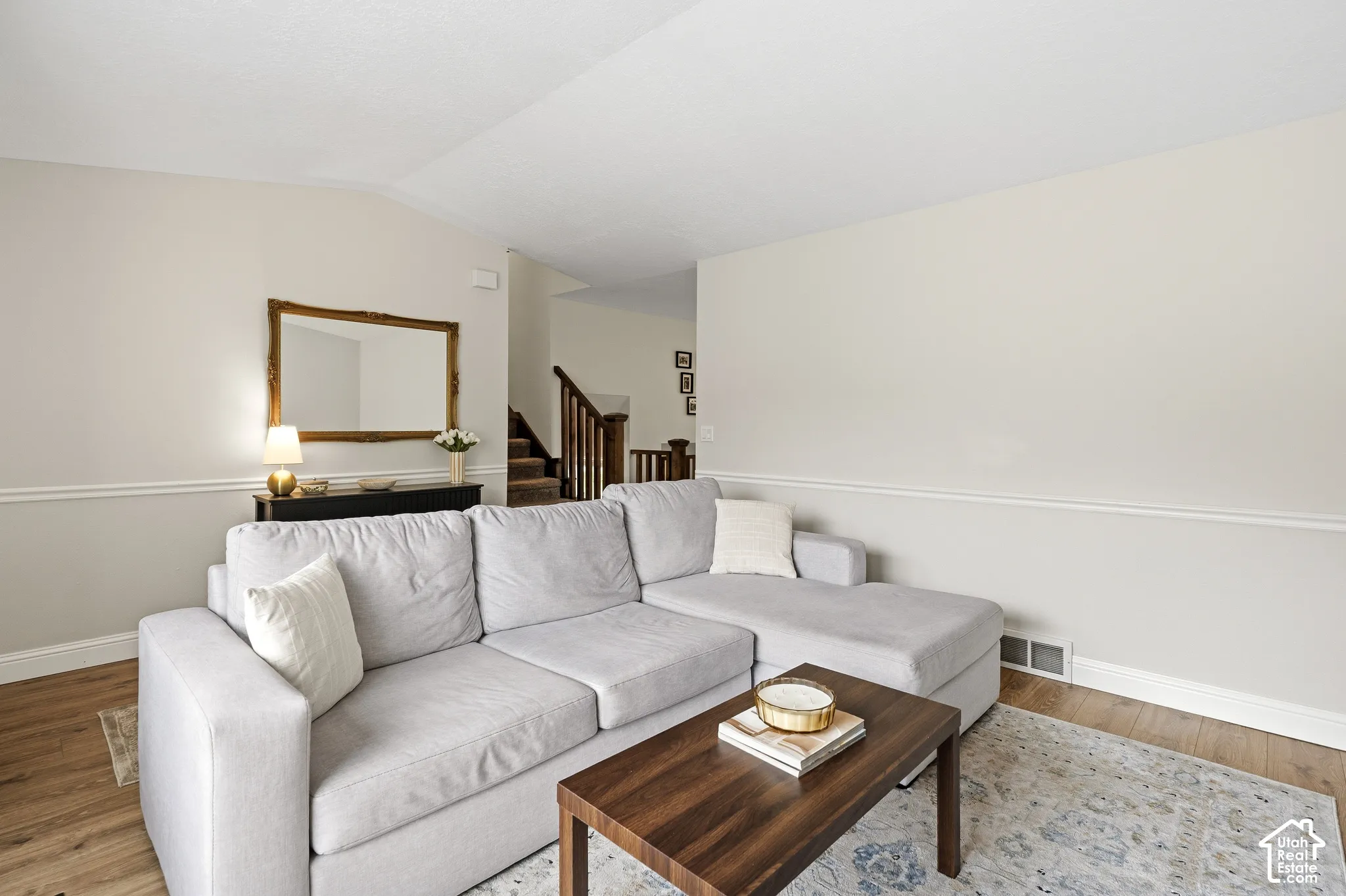 Wood-finish flooring complements neutral wall tones in this living space