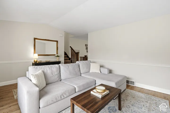 Wood-finish flooring complements neutral wall tones in this living space
