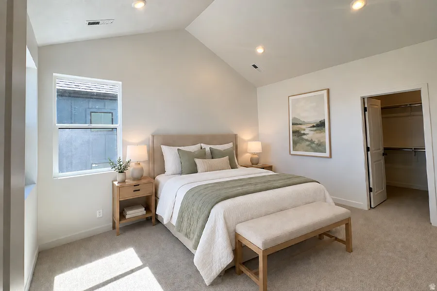 Vaulted ceilings, recessed lighting, double-pane window, neutral-toned carpeting, and a built-in closet