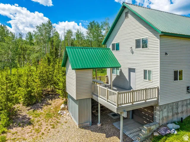 Multi-level siding exterior with a vibrant green metal roof