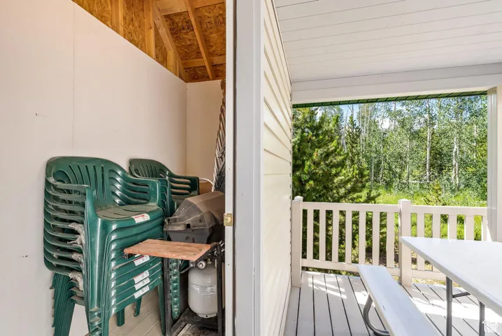 Outdoor patio with white railing and wood-finish decking