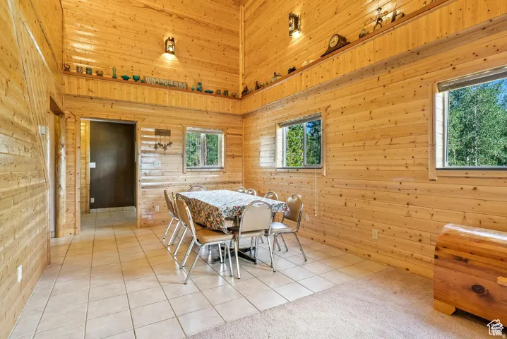 Interior space featuring full wood-paneled walls and a vaulted wood-paneled ceiling