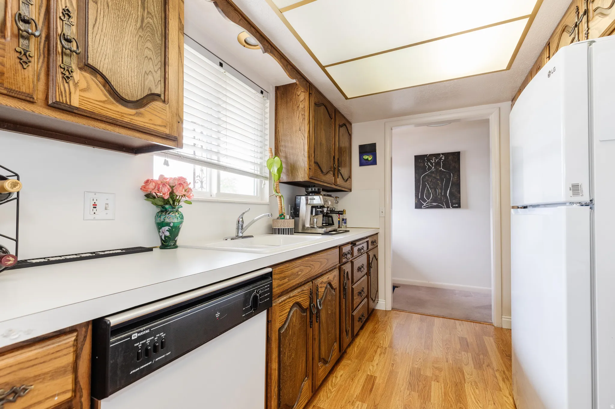 Kitchen featuring wood cabinetry, white countertops, and wood-finish flooring