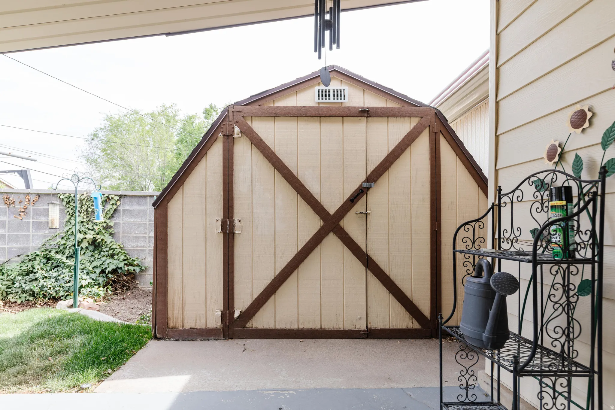 Gable-style storage shed with double doors and a vent