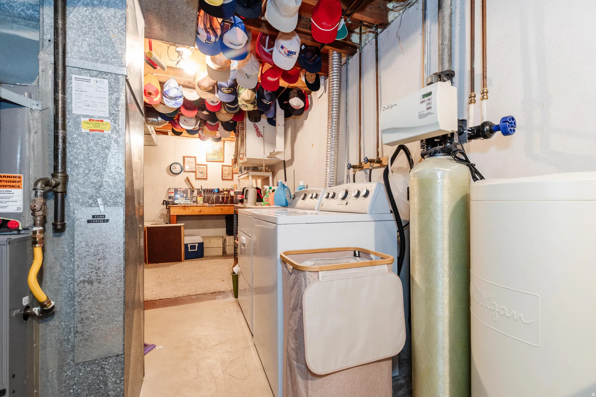 Dedicated laundry area featuring a white top-load washing machine and white walls