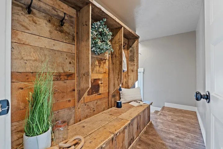 Built-in reclaimed wood bench with integrated cubbies and coat hooks