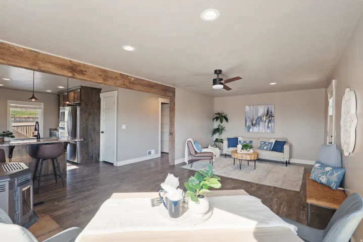 Open concept living space featuring wood-finish flooring, recessed lighting, and a dark wood ceiling fan