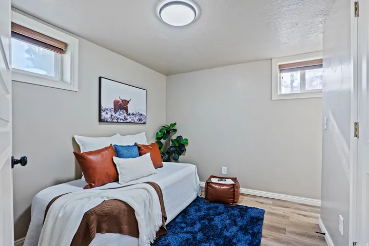 Interior room featuring light-toned walls, wood-finish flooring, and white trim