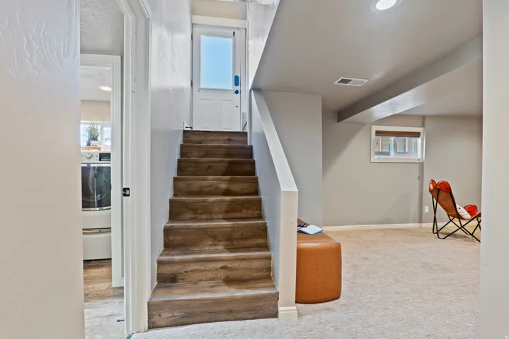 Wood-finish stair treads with white risers and handrail