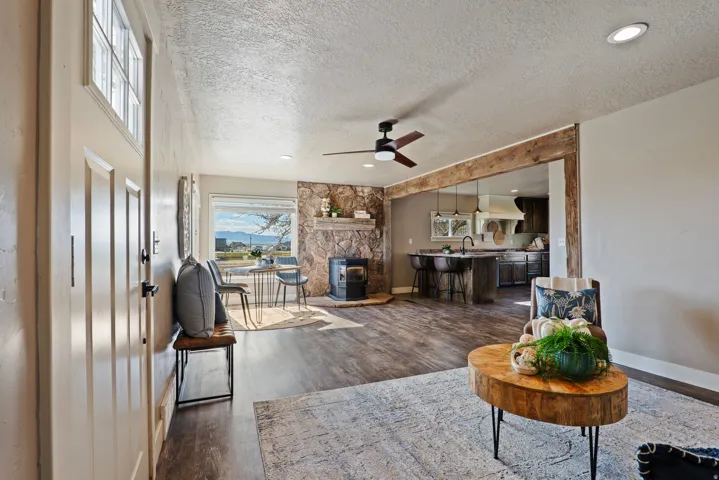 Open-concept living area with wood-finish flooring, recessed lighting, and a ceiling fan
