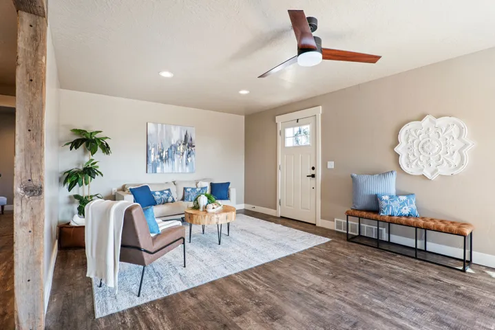 Spacious living area featuring wood-finish flooring, recessed lighting, and a modern ceiling fan