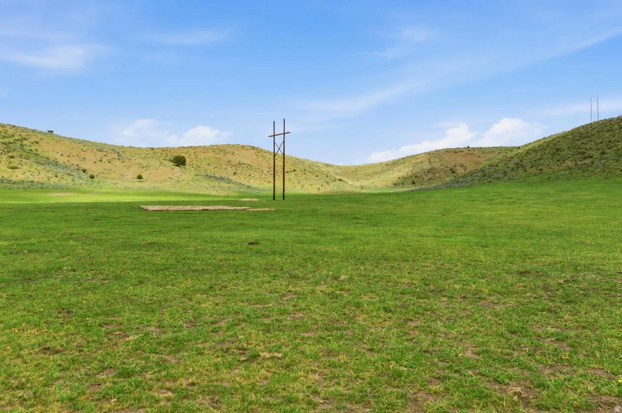Expansive green field with rolling hills and a clear blue sky on tax parcel rp0928.00