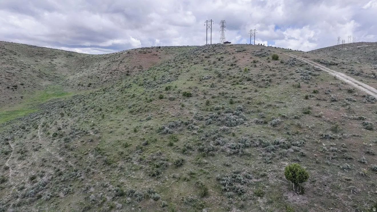 Expansive hill property featuring a natural landscape of brush and sparse vegetation