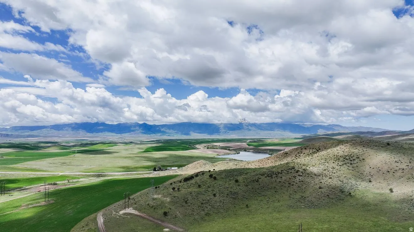 Expansive natural landscape featuring rolling hills and distant mountains