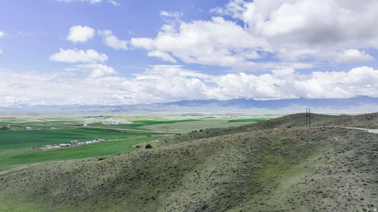 Expansive open landscape with rolling hills and distant mountains