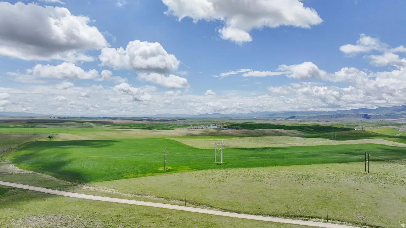 Expansive land parcel featuring open fields and distant mountains