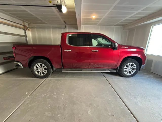 Spacious garage featuring a concrete floor, overhead lighting, and an automatic garage door opener