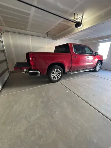 Spacious garage featuring a concrete floor, overhead garage door opener, and natural light from a frosted window