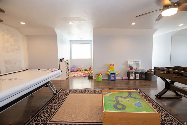 Spacious interior featuring wood-finish flooring, recessed lighting, and ceiling fans