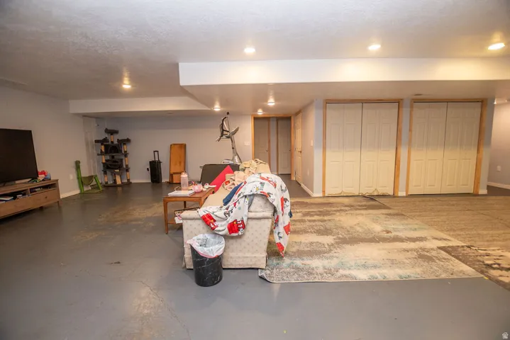 Spacious lower level featuring recessed lighting, light gray painted walls, and gray finished flooring
