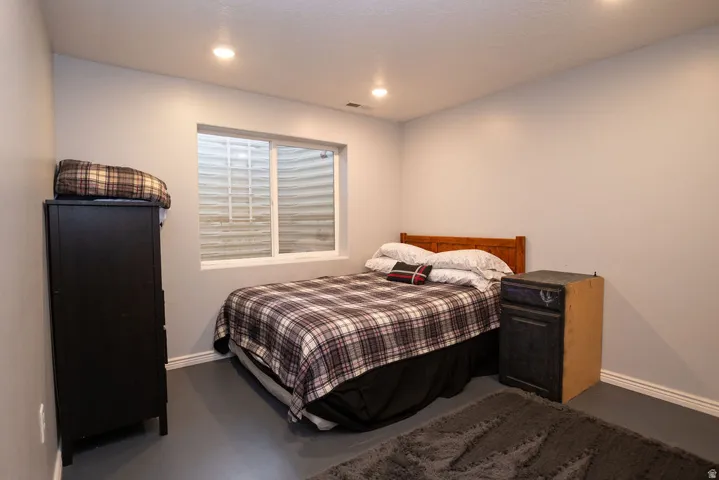 This room features neutral-toned walls, recessed lighting, and a white-framed window