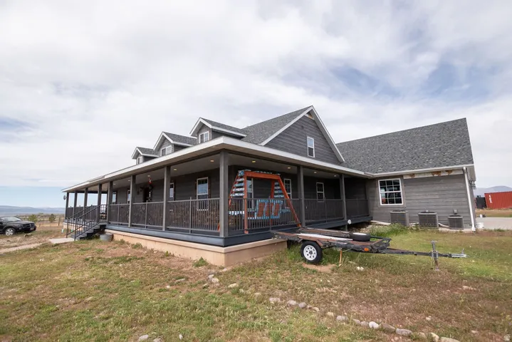 Contemporary ranch-style residence featuring a charcoal gray exterior siding
