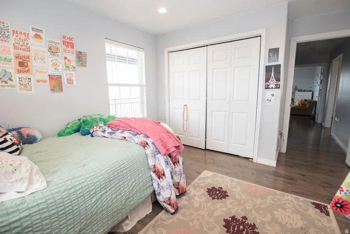 Recessed lighting illuminates wood-finish flooring